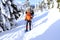 Winter hiking in the mountains on snowshoes with a backpack and tent.