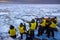 Winter Hokkaido, arctic polar photographic safari with eagles on the sea ocean ice. People with yellow vest on the boat vessel.