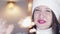 Winter holiday and Christmas celebration concept. Happy smiling woman in white winter knitted hat and sweater holding