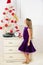 Winter holiday concept. Family holiday concept. Girl velvet dress feel festive near christmas tree. Make this day best