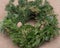 Winter holiday decoration: fraser fir table wreath centerpiece with cones and juniper on burlap