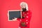 Winter holiday. Schedule timing concept. Bearded man blank blackboard copy space. Guy santa claus red background