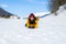 Winter holiday trip to snow valley - young happy and excited Asian Chinese woman playful on frozen lake in snowy mountains at