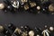 Winter holidays celebration with an elegant, chic, and modern Christmas composition. Golden gift boxes, baubles, and confetti on a