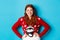 Winter holidays and Christmas Eve concept. Beautiful teenage redhead girl in xmas sweater looking at camera, smiling