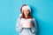 Winter holidays and Christmas Eve concept. Sassy redhead girl in sweater and Santa hat, holding New Year gift and