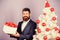 Winter holidays. Christmas greetings. Best gifts for colleagues. Office christmas party. Man bearded hipster formal suit