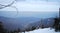 Winter horizontal mountains landscape with smog from city in background.