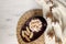 Winter hot chocolate flat lay - hot chocolate with marshmallows, cookies, dried cotton branch on straw placemat, knitted plaid,