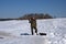 Winter ice fishing, a fisherman in warm clothes fishing in the hole - Russia Berezniki 7 April 2018 .