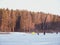 Winter ice fishing, lake, forest, frosty day. fishermans