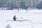 Winter ice fishing, lake, frosty day. Fisherman engaged in ice fishing in the pond of the city Park