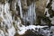 Winter ice on the walls of the ravine of Lake Smeraldo in Fondo