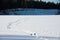 Winter on the lake with ice and lots of snow. Human footprints