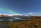 Winter lake near mountain in Hofn, Iceland. Northern lights and