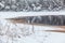 Winter lake shore with opened water in ice