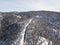 Winter landscape from above, car passing on a road