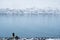 Winter landscape of Akureyri city in Iceland with a man taking photograph