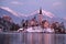 Winter landscape of Bled Lake and island church on sunset