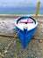 Winter landscape, blue boat and yellow shower tower on a beach covered with snow, Pieria, Greece