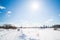 Winter landscape. Countryside. Snowy road. Sunny day. Blue sky. White clouds.