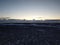 Winter landscape, deserted walking road through a field to the beach in iceland. Huge open space, the road is marked with yellow