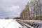 Winter landscape with ditch trench near forest