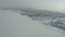 Winter landscape from a drone.Clip.A white landscape on a winter frozen city where houses and a frozen river are visible