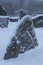 A winter landscape filled with snow and ice. Big stones covered by snow and ice.