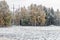 Winter landscape with first snow in the countryside fields with late autumn colors