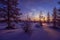 Winter landscape with forest, cloudy sky and sun