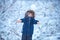 Winter landscape of forest and snow with cute child boy. Enjoying nature wintertime. Happy winter time. Well dressed