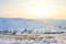 Winter landscape with hill and unrecognized people silhouette skiing in distanse