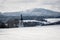 Winter landscape hilly scenery with church, snow and trees in the Czech Republic