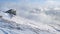 Winter landscape with a house on the mountain with haze and snow