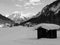 Winter landscape with houses and mountains in black and white