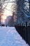 Winter landscape iron fence at sunset