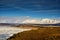 Winter landscape of Mongolia. White mountain background and yellow valley