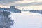 Winter landscape in Moscow, Russia. Scenery of Moskva River covered ice and snow in sunlight. Panoramic view of frozen river for