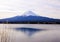 Winter landscape with Mount Fuji, village and lake.