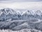 Winter landscape with mountain peaks covered in snow. Beautiful view with Bucegi Mountains part of the Carpathian Mountains, in