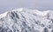 Winter landscape with mountain peaks covered in snow. Beautiful view with Bucegi Mountains part of the Carpathian Mountains, in