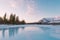 Winter landscape on the mountains and the frozen lake in Yakutia, Siberia, Russia. Light pink clouds in the morning light