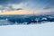 Winter landscape in the mountains on ski resort near chairlift on sunset. Snow covered hills after heavy snowfall. Snowy