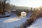 Winter landscape with old bridge sunny day