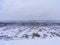 Winter landscape of old slavic willage with wooden traditional russian houses and snowy field