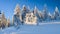 Winter landscape in the Polish mountains of the Sudetes, snow-covered forest on a hiking trail in the mountains, thick snow cover