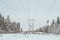 Winter landscape power lines in a snowy field in the forest