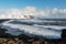 Winter landscape with Reynisdrangar stacks, black sand beach and ocean waves, Iceland