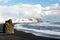 Winter landscape with Reynisdrangar stacks, mountain, black sand beach and ocean waves, Iceland